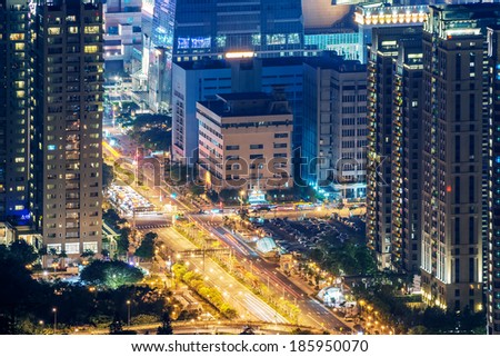 Modern city night with skyscrapers and cars light at road in Taipei, Taiwan, Asia.