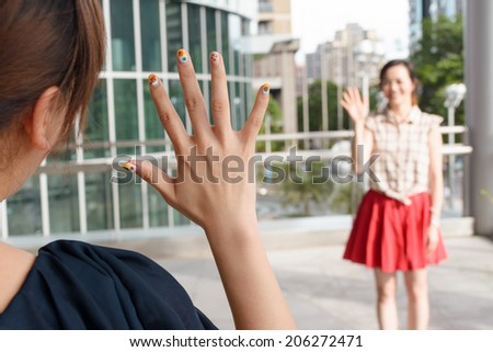 Asian woman meet her friends in the outside.