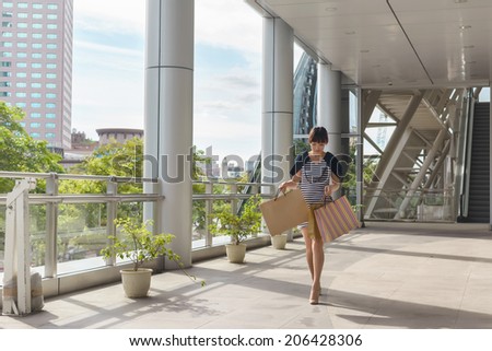 Attractive Asian beauty shopping and walking in the city.