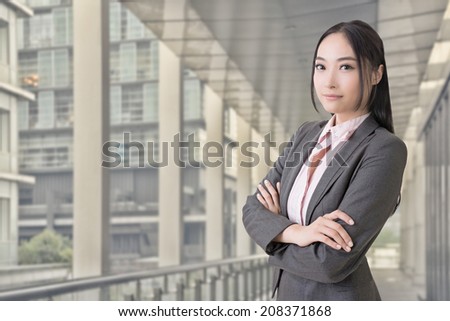 Attractive Asian business woman look at you, closeup portrait isolated on white background.