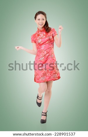 Smiling Chinese woman dress traditional cheongsam at New Year, studio shot isolated.