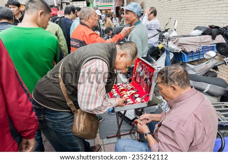 TAIPEI, TAIWAN - November 16th : Street vendor selling various watches near Longshan Temple, Taipei, Taiwan on November 16th, 2014.