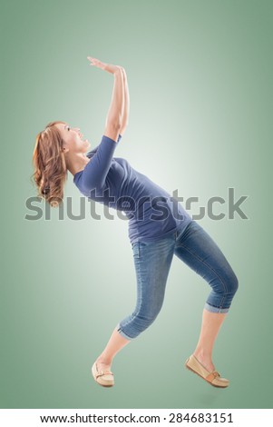 Full length portrait of Asian woman under stress, isolated on studio background.