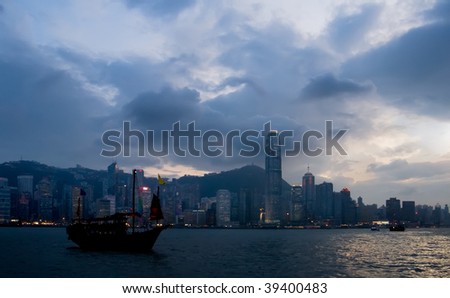 It is silhouette of Victoria harbor old Chinese style boat in Hong Kong.
