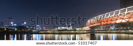 City night scenic of panorama with buildings and color bridge in Kaohsiung, Taiwan.