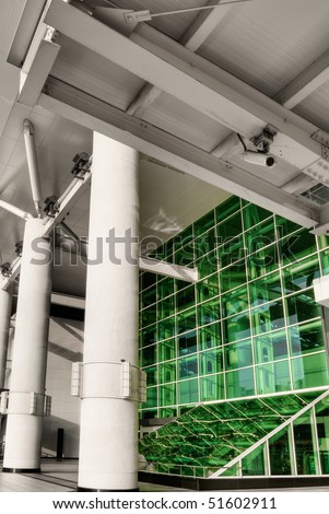 Green windows in station with pillar in modern city.