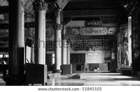 Building interior structure of Chinese temple with column and inscription.
