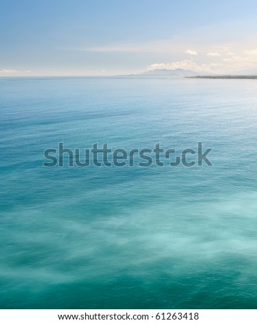 Nature background of sea with green ocean under blue sky.