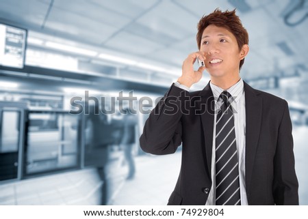 Business man using cellphone when waiting in station.