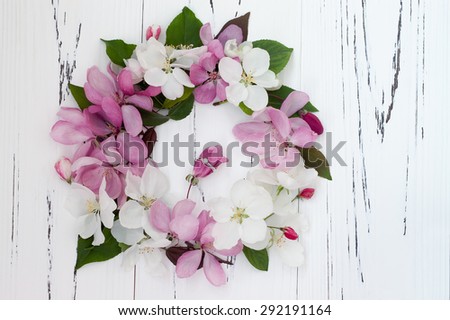Diamond ring with spring apple tree blossoms on white old wooden background. Wedding concept