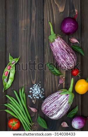 Mix of fresh farmers market vegetable from above on the old wooden board with copy space. Healthy eating background. Top view