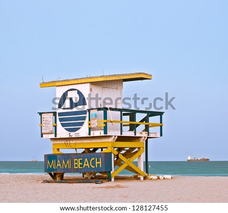 Summer scene in Miami Beach Florida, with a colorful lifeguard house in a typical Art Deco architecture, at sunset with blue sky in the background. Long exposure.