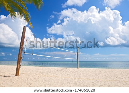 Beach volleyball court on a beautiful summer day in Florida with ocean and blue cloudy sky