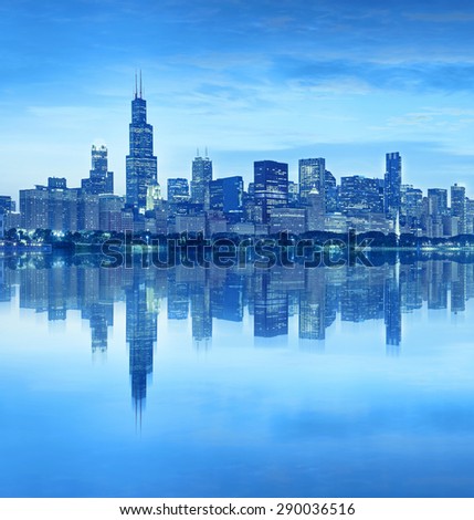 Chicago Illinois USA, blue color processed panorama of city downtown skyline at sunset with illuminated buildings, park and lake reflections
