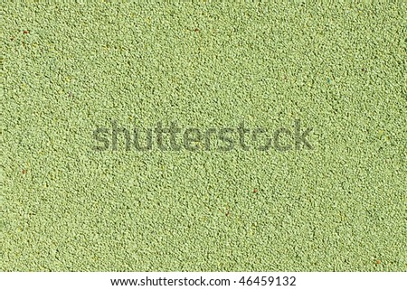 Background texture of green crumb rubber used for athletic tracks and children playgrounds
