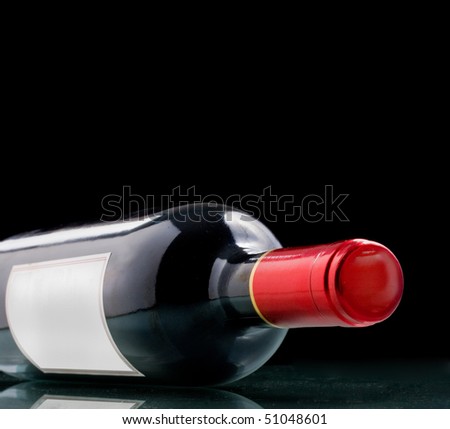 Wine bottle with blank paper generic tag on black background