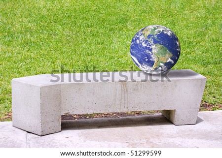 Planet Earth on a concrete bench in a public park. Conceptual environmental image