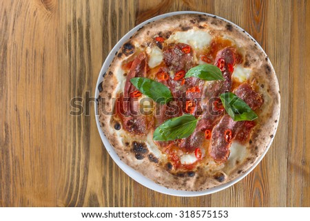 Wood fired oven Pizza with smoked speck, chili and basil