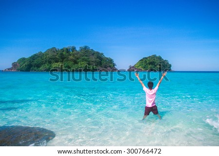 A man feel so happy on his beach traveling