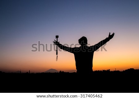Tourist with camera takes enjoy the sun rises with happy acting