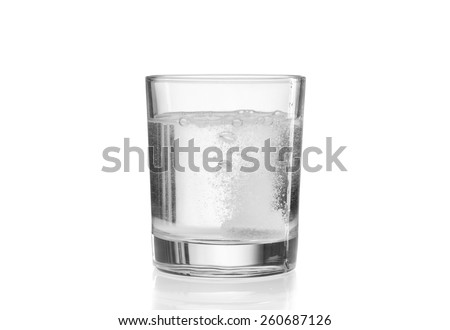 Glass with efervescent tablet in water. Isolated on white. Imagine de stoc © 