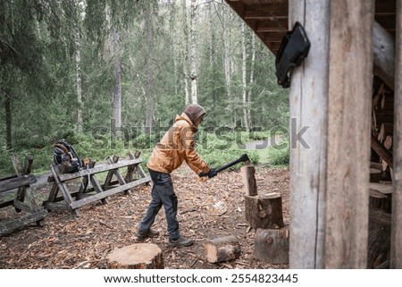 Similar – Foto Bild Mann mit Brennholz beim Lagerfeuermachen im Wald