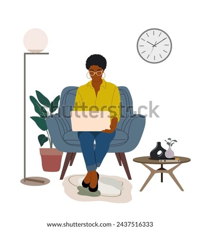 Black business woman working at laptop at home.