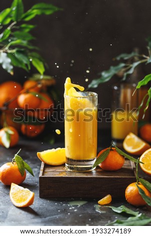 Similar – Foto Bild Frischer Saft und Mandarinen auf schwarzem Tisch