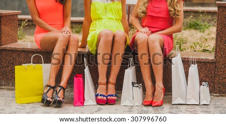 women in bright dress with beautiful legs and shopping bags shopping cropped image sale