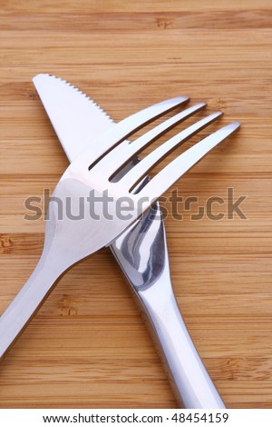 Solid fork and knife on wood table