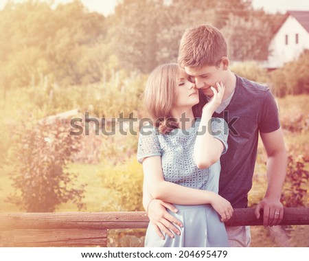 Stunning sensual outdoor portrait of young stylish fashion couple posing in summer