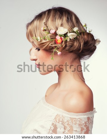 Beautiful girl with flowers in her hair. Spring.