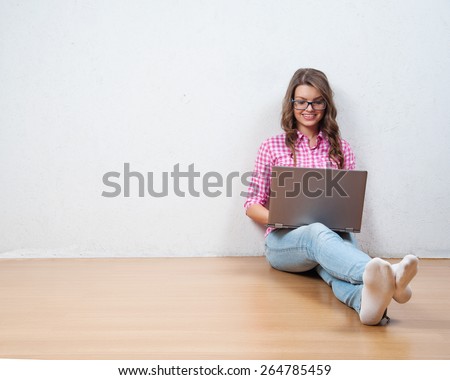 Young creative woman sitting in the floor with laptop. Casual blogger woman