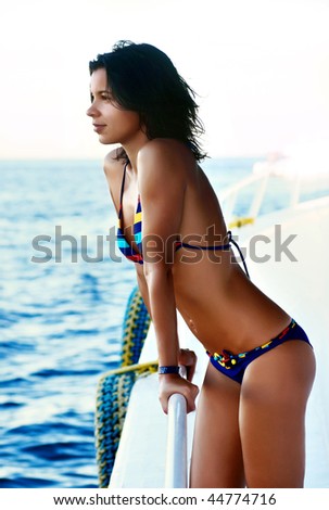 A beautiful young woman taking in the sun at the boat