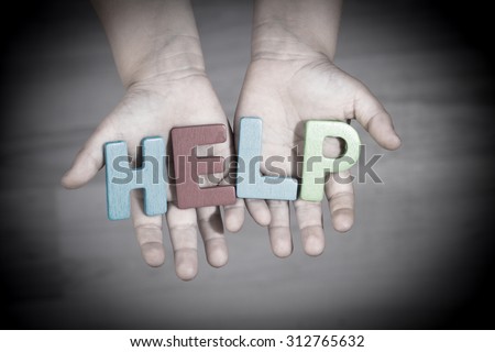 The child asks for help. Written help letters on the palms
