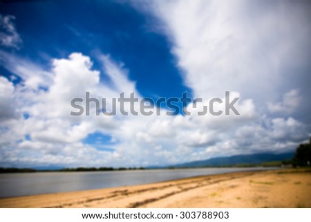 Blue sky and sea and sand background lens blur concept.