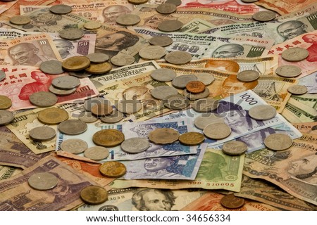 A mixed pile of Foreign money including US, Taiwan, India, Hong Kong, Honduras, Malaysia and Korea currency