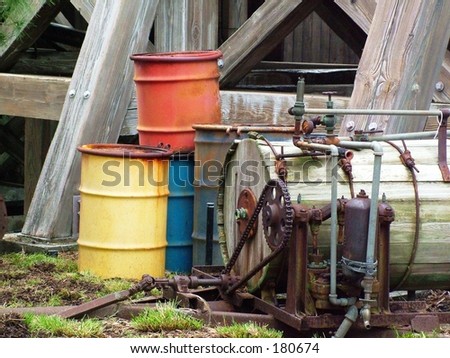 Old machinery and barrels under bridge