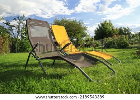 two sun loungers standing on the grass in the garden Zdjęcia stock © 
