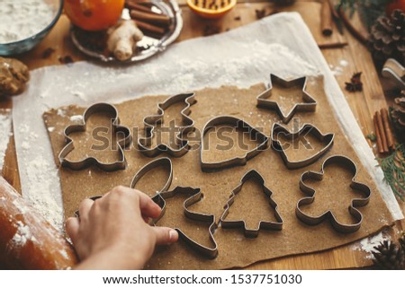 Similar – Image, Stock Photo Gingerbread cookies dough cut in different shapes on a blue table. Baking Christmas cookies