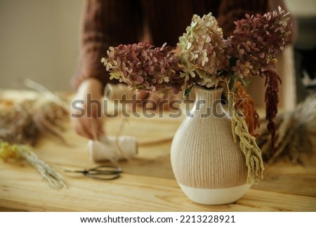 Similar – Image, Stock Photo Dry hydrangea flowers in neutral colors on a table in the living room at home. Apartment decor in minimalist style with soft warm sunny light.