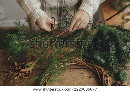 Similar – Image, Stock Photo Woman making Christmas wreath of spruce, step by step. Concept of florist’s work before the Christmas holidays.