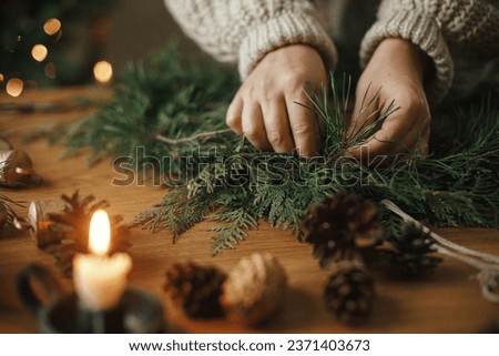 Similar – Image, Stock Photo Woman making Christmas wreath of spruce, step by step. Concept of florist’s work before the Christmas holidays.