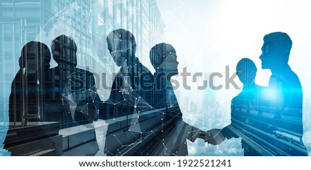 Silhouette view of business people team in group meeting on city office building background showing partnership success of business deal. Concept of teamwork, trust and agreement.