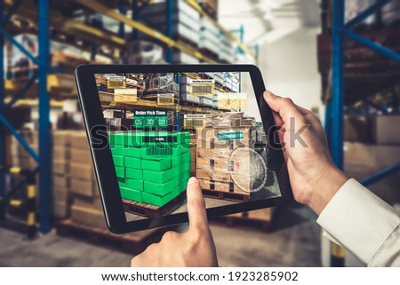 Smart warehouse management system using augmented reality technology to identify package picking and delivery . Future concept of supply chain and logistic business .