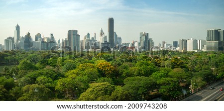 Public park and high-rise buildings cityscape in metropolis city center . Green environment city and downtown business district in panoramic view .