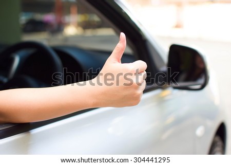 woman thumbs up for good car