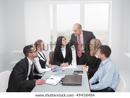 Team and their leader. Group of businesspeople formed of businessmen and women in an office with their chief