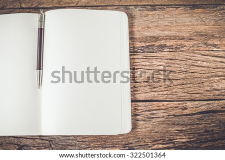 White blank pages sketch book on wood table,Vintage color tone