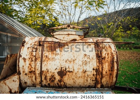 Similar – Image, Stock Photo Vintage water tank on high rusty iron frame in front of grey clouds